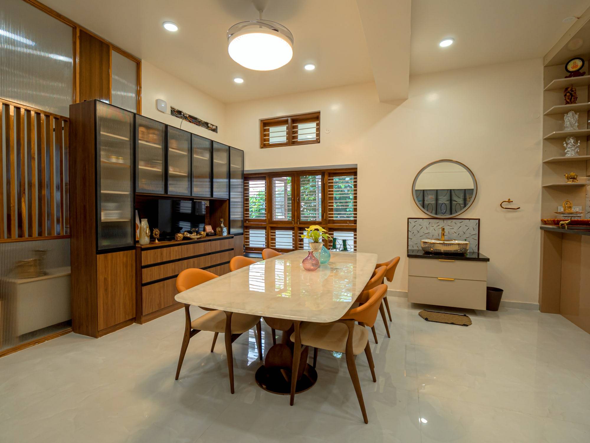 Dining area with marble dining table and fluted glass crockery credenza