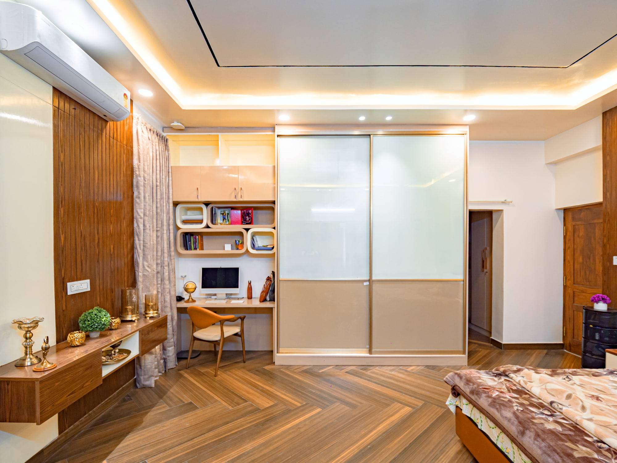 Master bedroom with sliding wardrobe and herringbone flooring
