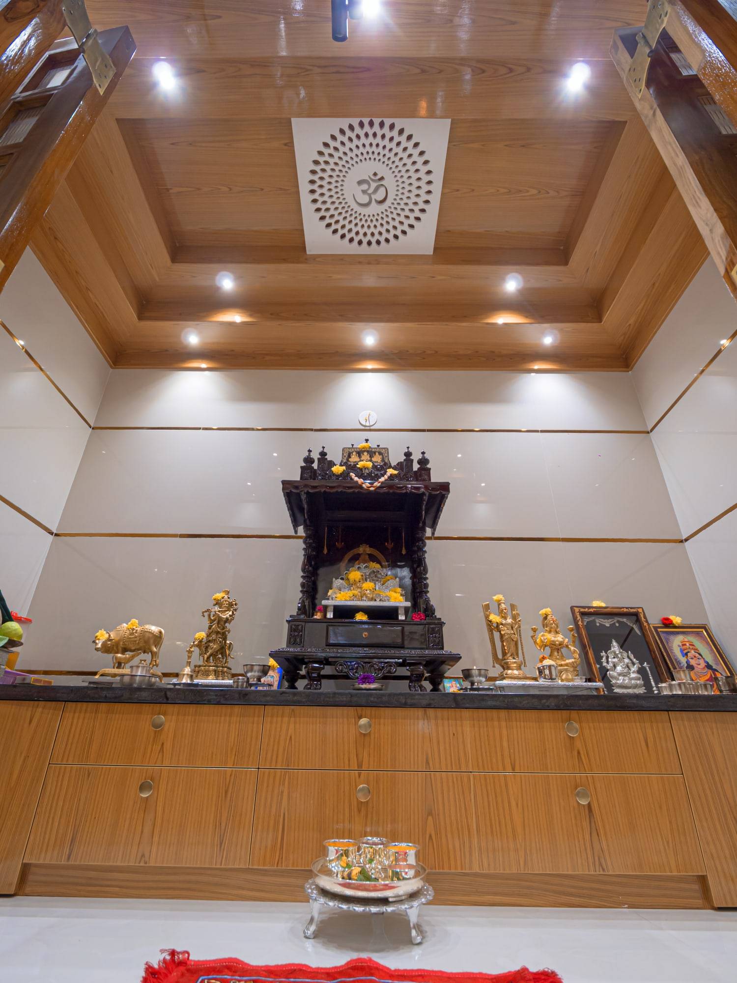 Handcrafted wooden pooja mandir with illuminated Om ceiling