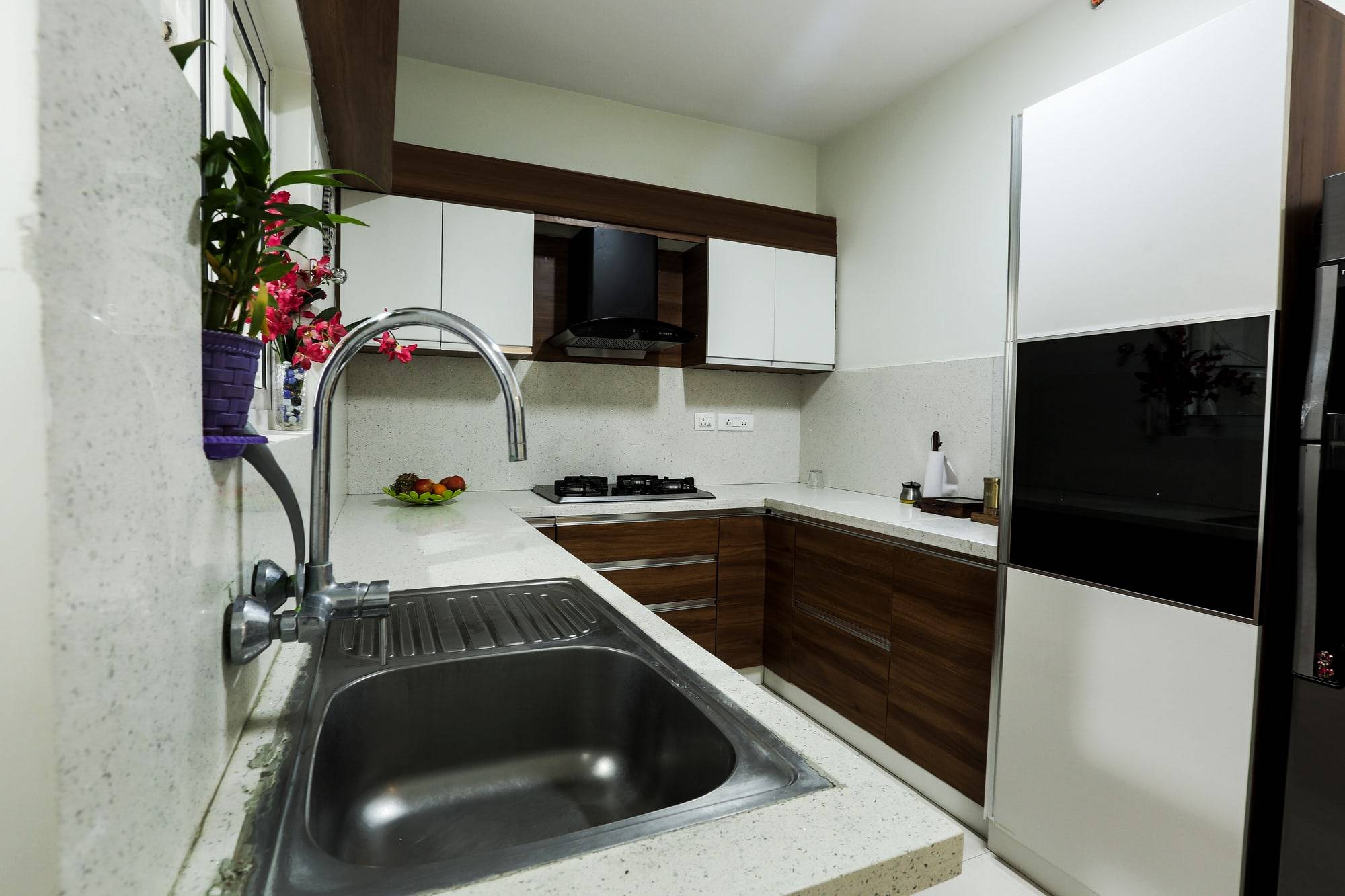 Kitchen washing zone with deep stainless sink and built-in tall appliance unit