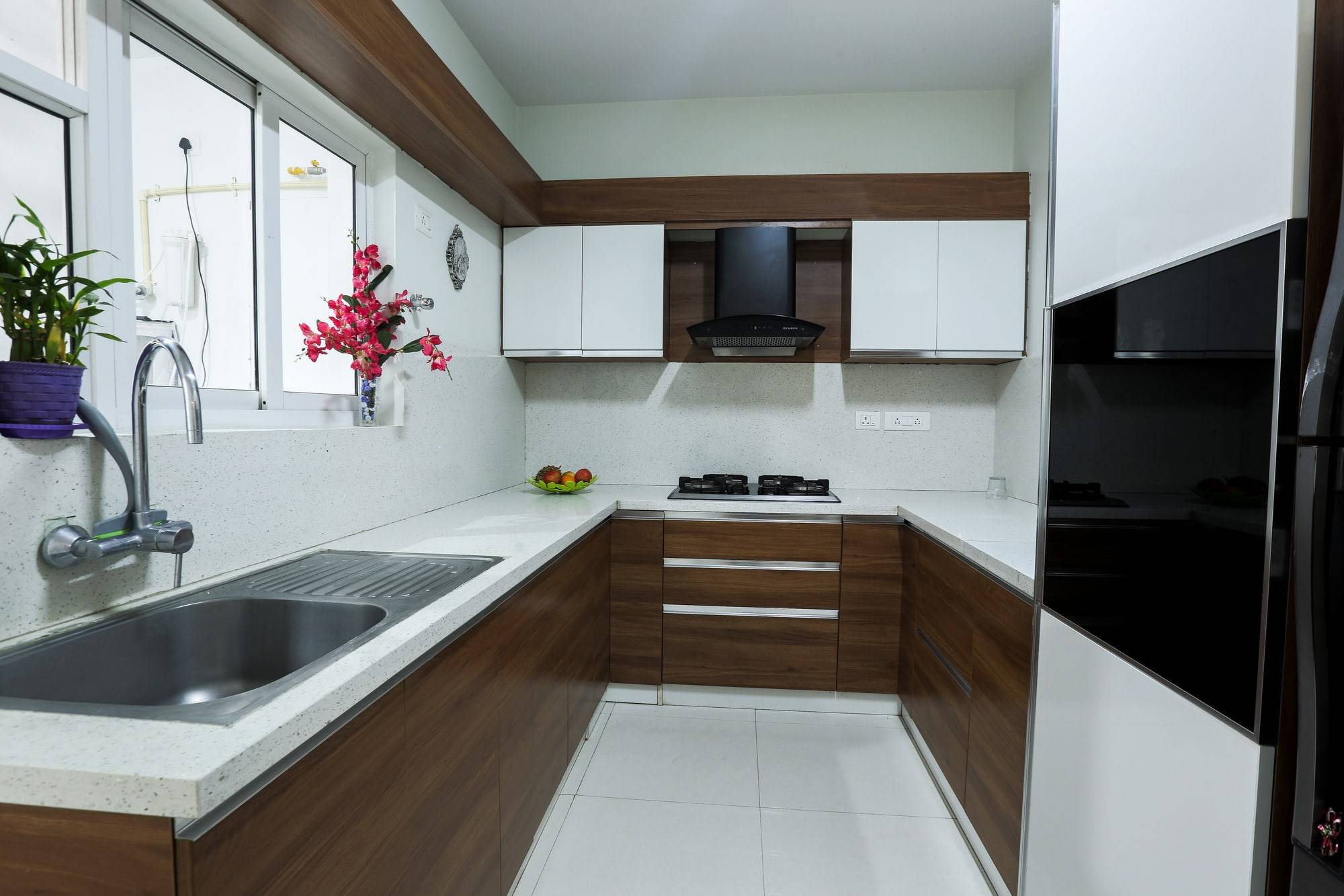 U-shaped modular kitchen with walnut base cabinets and white overheads
