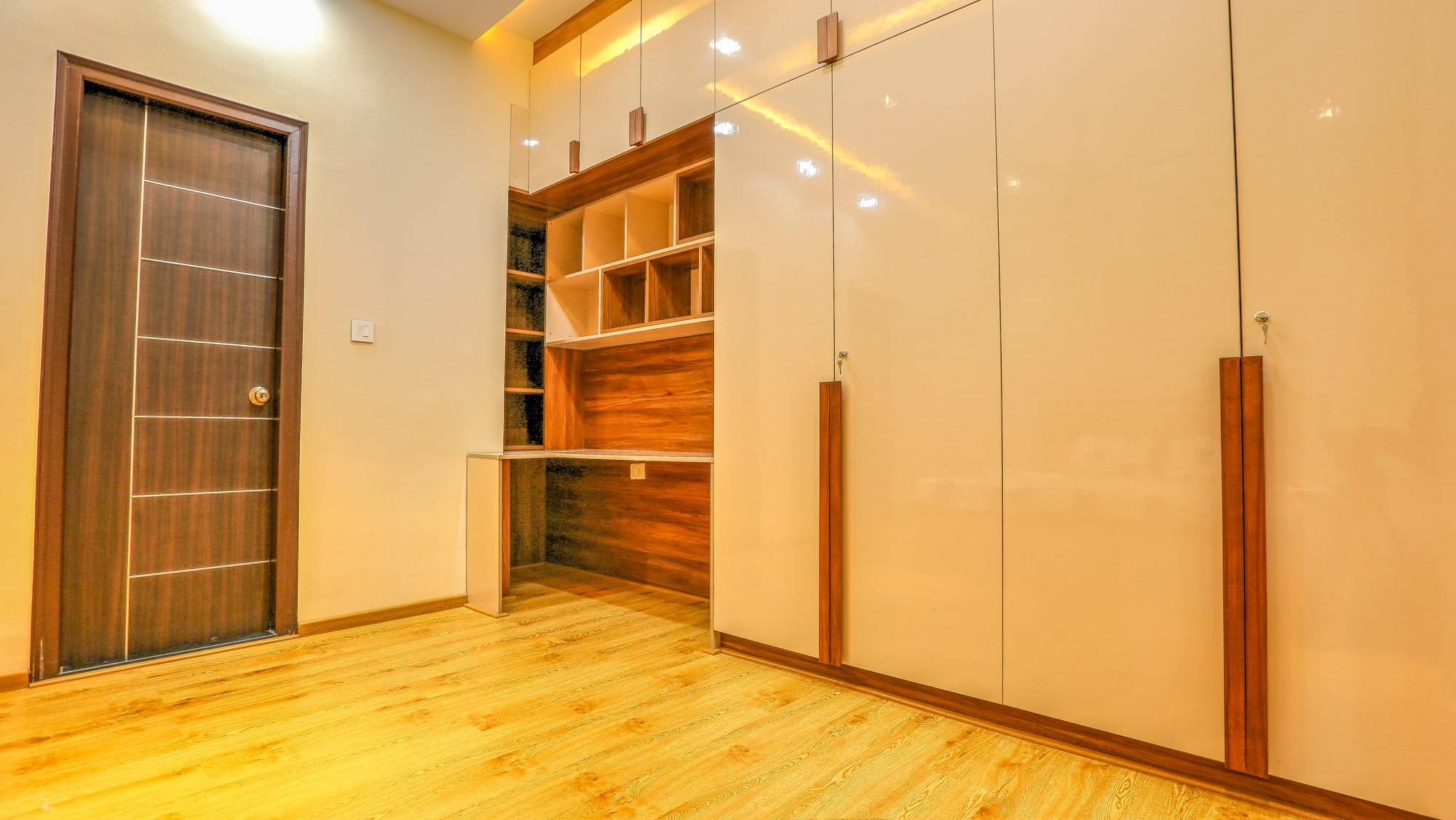 Full-height bedroom wardrobes with overhead lofts and integrated study niche