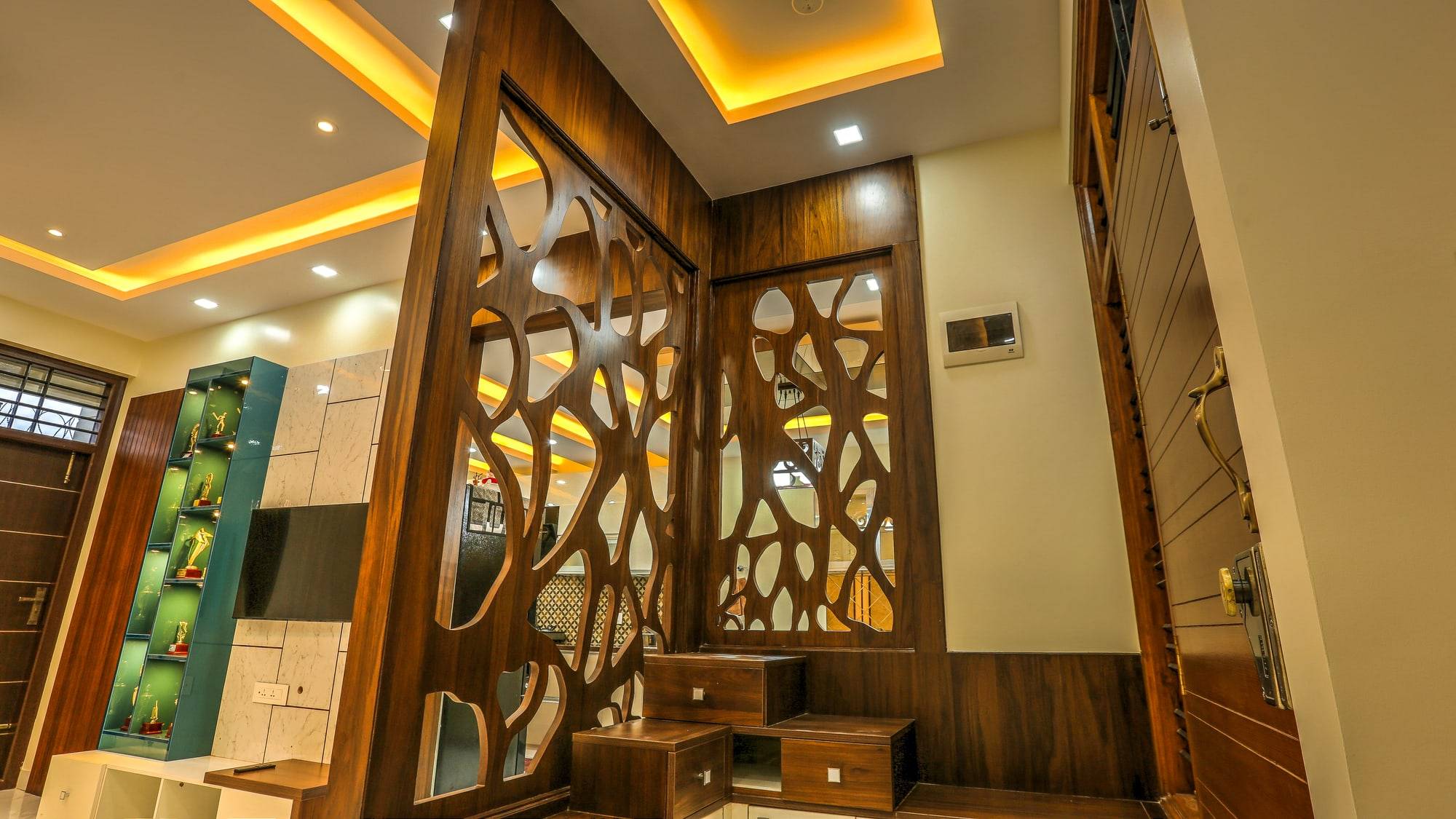 Detail of organic tree-branch wood partition screen with stepped drawers