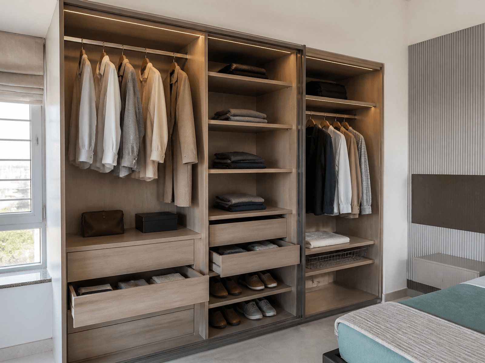 Open wardrobe internals with hanging and drawers