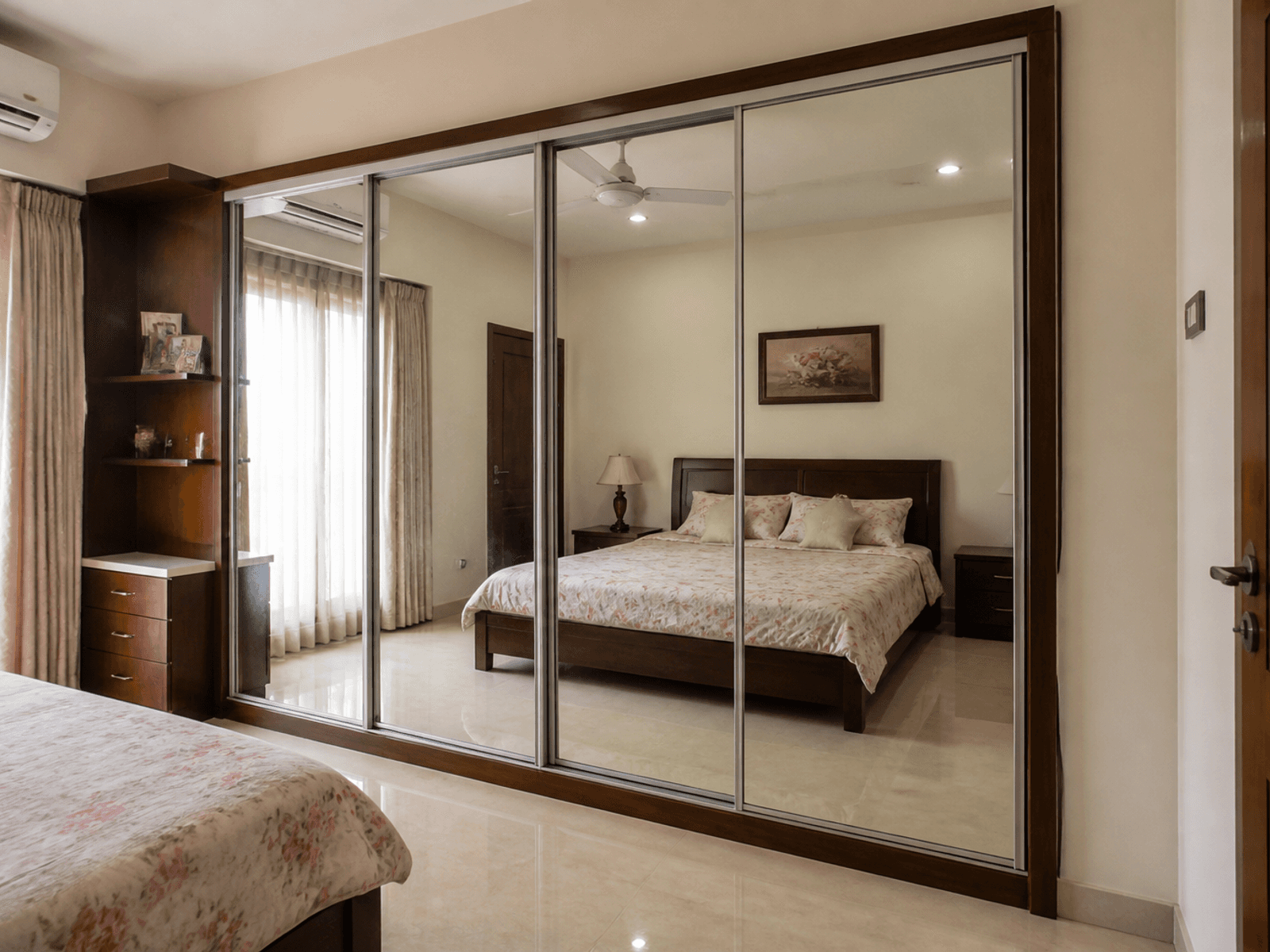 Mirrored sliding wardrobe in a bedroom
